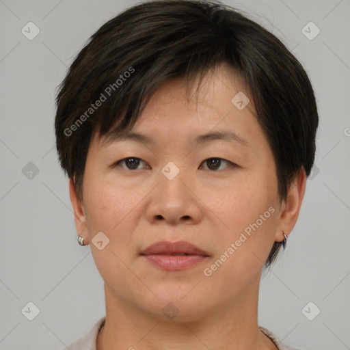 Joyful asian adult female with short  brown hair and brown eyes