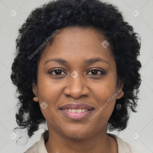 Joyful black adult female with medium  brown hair and brown eyes