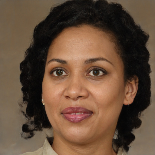 Joyful black adult female with medium  brown hair and brown eyes