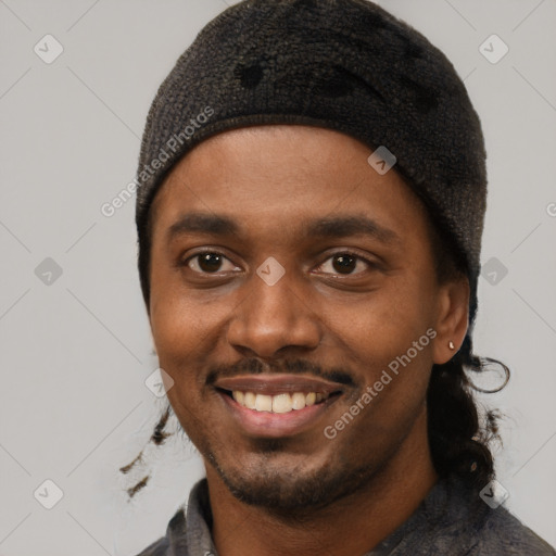 Joyful black young-adult male with short  black hair and brown eyes