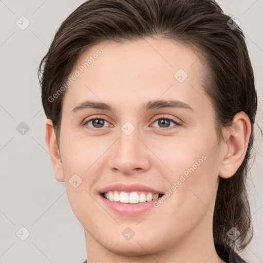 Joyful white young-adult female with medium  brown hair and grey eyes