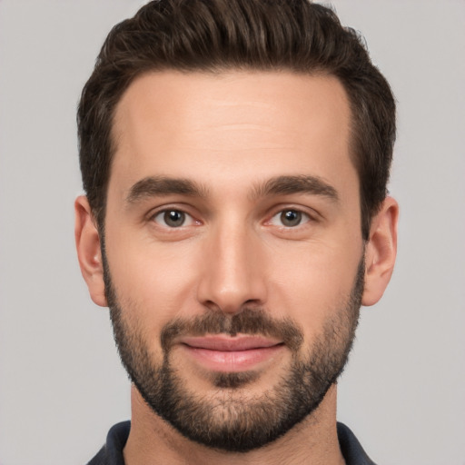 Joyful white young-adult male with short  brown hair and brown eyes