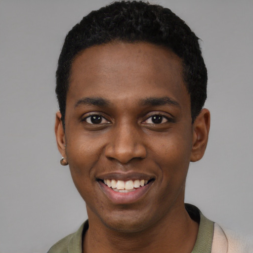 Joyful black young-adult male with short  black hair and brown eyes