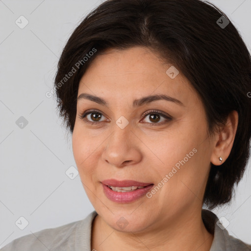 Joyful white adult female with medium  brown hair and brown eyes