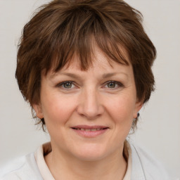 Joyful white adult female with medium  brown hair and grey eyes