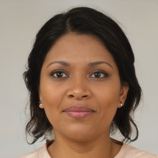 Joyful black young-adult female with medium  brown hair and brown eyes