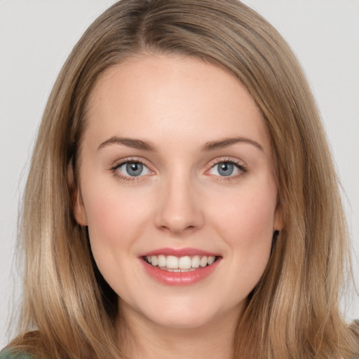 Joyful white young-adult female with long  brown hair and grey eyes