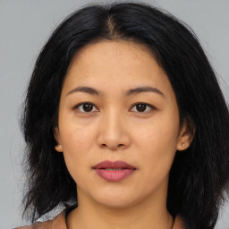 Joyful asian young-adult female with medium  black hair and brown eyes