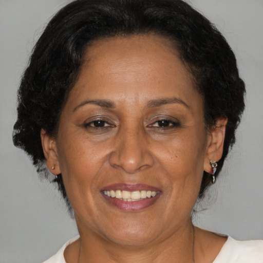 Joyful latino adult female with medium  brown hair and brown eyes