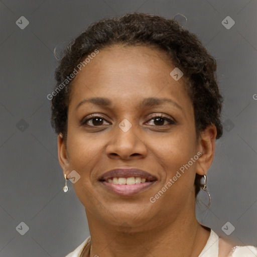 Joyful black young-adult female with short  brown hair and brown eyes