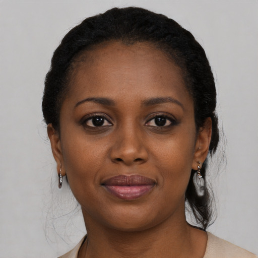 Joyful black young-adult female with medium  black hair and brown eyes