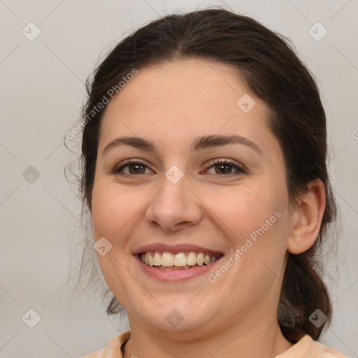 Joyful white adult female with medium  brown hair and brown eyes