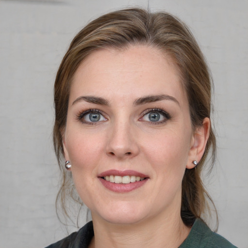 Joyful white young-adult female with medium  brown hair and blue eyes