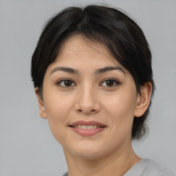 Joyful asian young-adult female with medium  brown hair and brown eyes