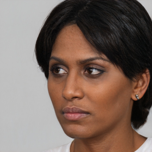 Neutral black young-adult female with medium  black hair and brown eyes