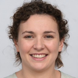 Joyful white young-adult female with medium  brown hair and blue eyes