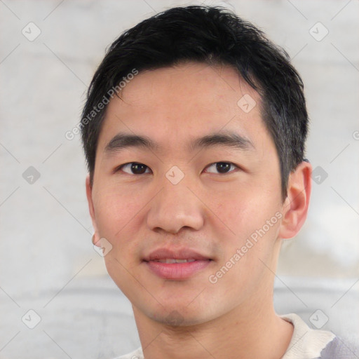 Joyful asian young-adult male with short  black hair and brown eyes