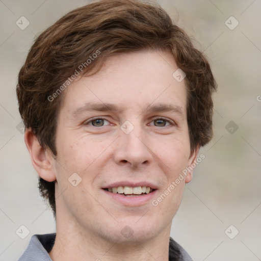 Joyful white adult male with short  brown hair and grey eyes