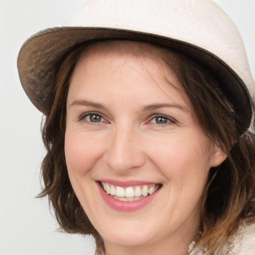 Joyful white adult female with medium  brown hair and brown eyes