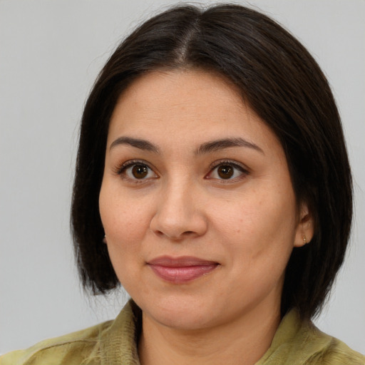 Joyful asian young-adult female with medium  brown hair and brown eyes