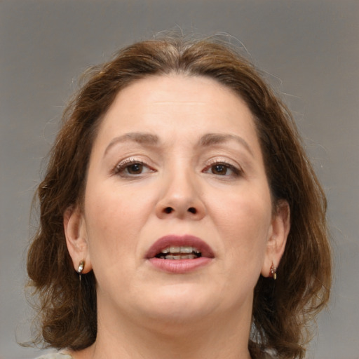 Joyful white adult female with medium  brown hair and brown eyes