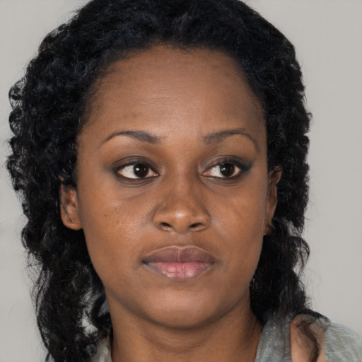 Neutral black young-adult female with long  brown hair and brown eyes