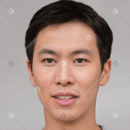 Joyful asian young-adult male with short  brown hair and brown eyes