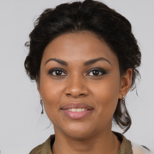 Joyful black young-adult female with medium  brown hair and brown eyes