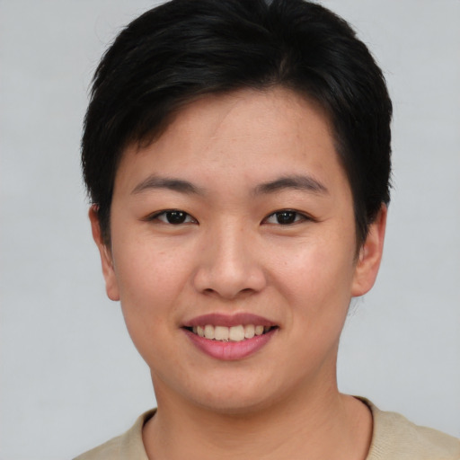 Joyful asian young-adult female with short  brown hair and brown eyes