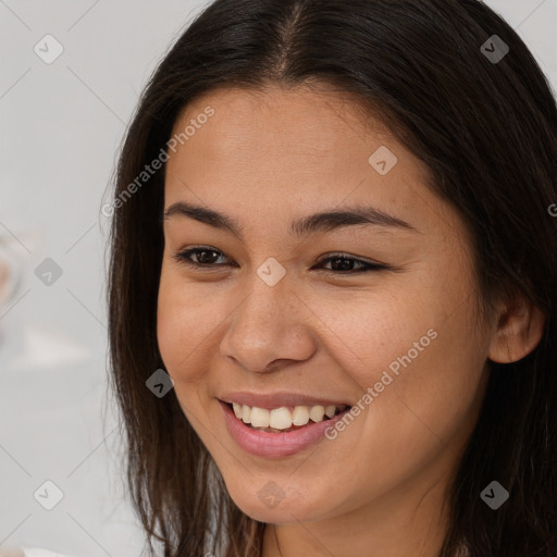 Joyful asian young-adult female with long  brown hair and brown eyes