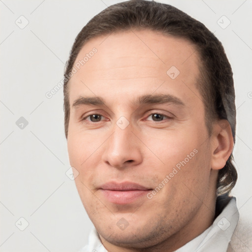 Joyful white young-adult male with short  brown hair and brown eyes