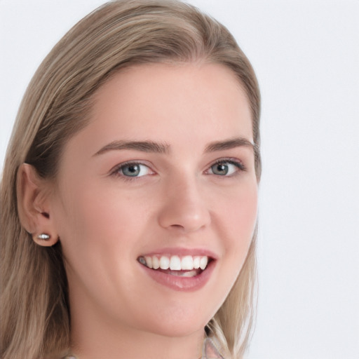 Joyful white young-adult female with long  brown hair and blue eyes