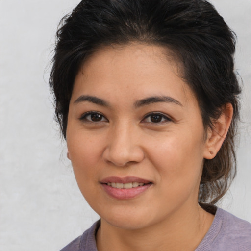 Joyful latino young-adult female with medium  brown hair and brown eyes