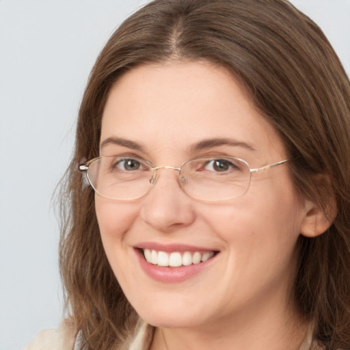 Joyful white young-adult female with long  brown hair and green eyes