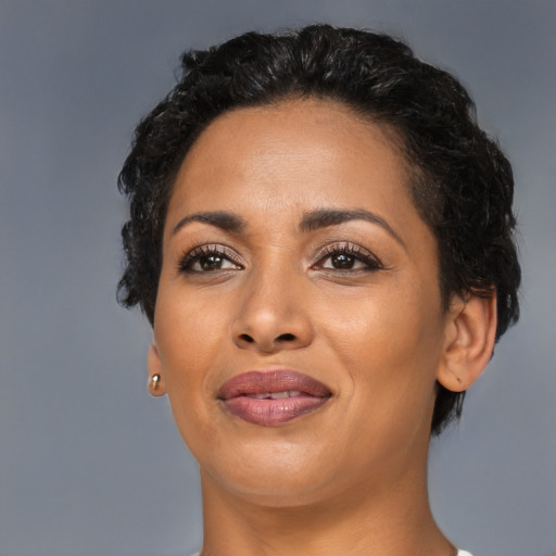 Joyful latino young-adult female with short  black hair and brown eyes