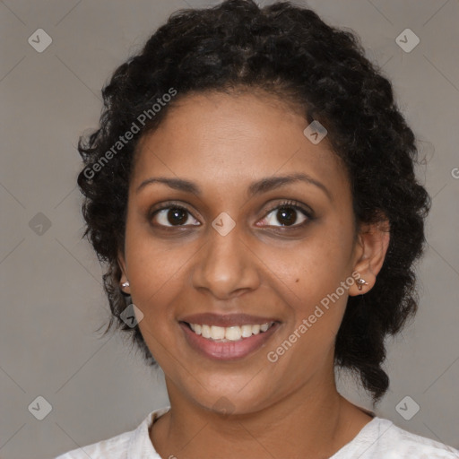 Joyful black young-adult female with medium  brown hair and brown eyes