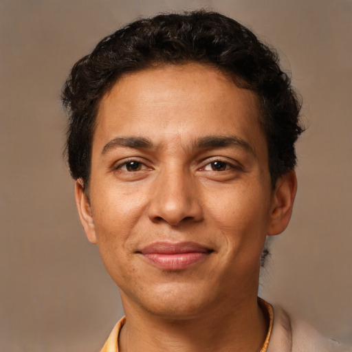 Joyful latino young-adult male with short  brown hair and brown eyes