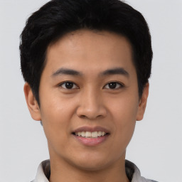 Joyful asian young-adult male with short  black hair and brown eyes