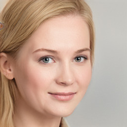 Joyful white young-adult female with long  brown hair and blue eyes