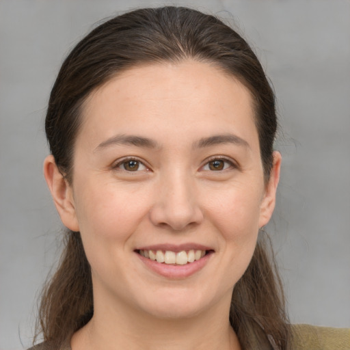 Joyful white young-adult female with medium  brown hair and brown eyes