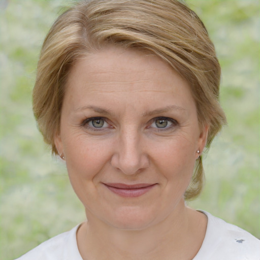 Joyful white adult female with medium  brown hair and brown eyes