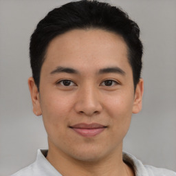 Joyful latino young-adult male with short  brown hair and brown eyes