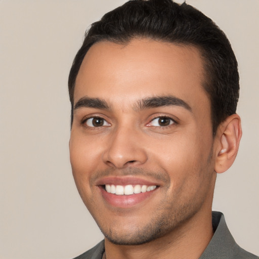 Joyful white young-adult male with short  black hair and brown eyes