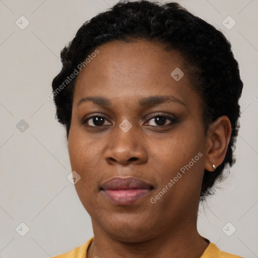 Joyful black young-adult female with short  black hair and brown eyes