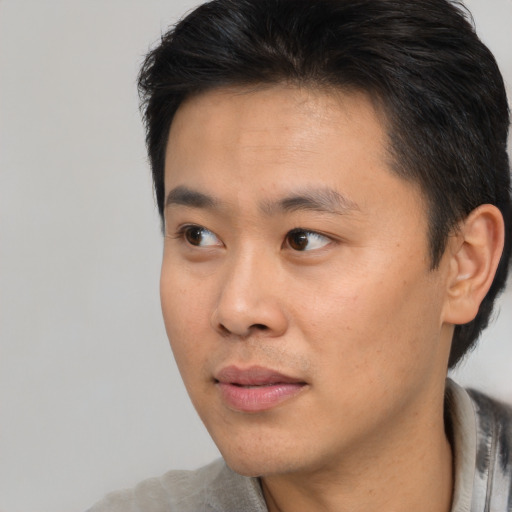 Neutral asian young-adult male with short  brown hair and brown eyes
