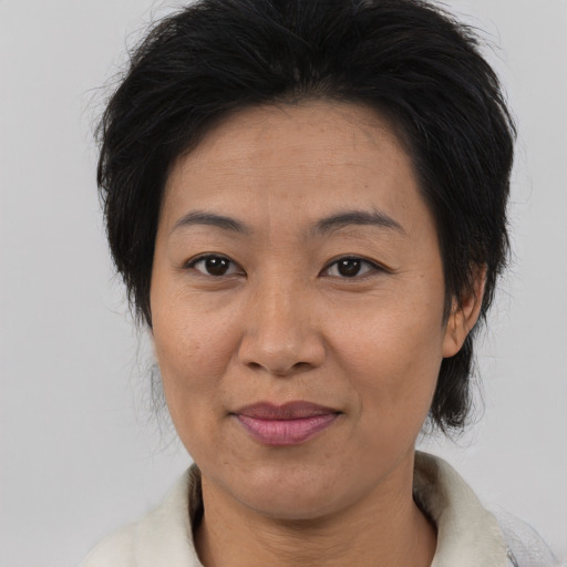 Joyful asian adult female with medium  brown hair and brown eyes