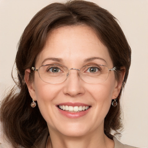 Joyful white adult female with medium  brown hair and grey eyes