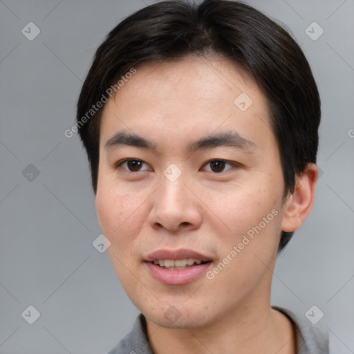 Joyful asian young-adult male with short  brown hair and brown eyes