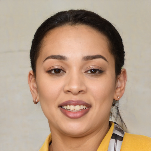 Joyful latino young-adult female with short  brown hair and brown eyes