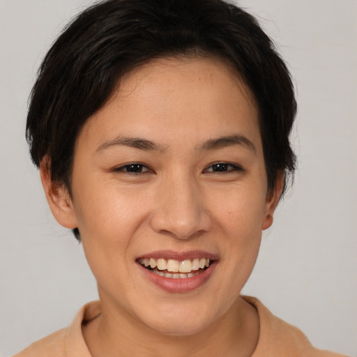 Joyful asian young-adult female with medium  brown hair and brown eyes